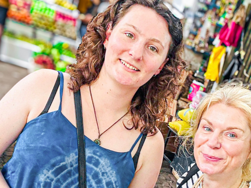Tourists exploring vibrant local market with guide on Colombo food tour itinerary in Colombo
