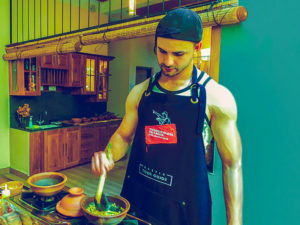 A Male Student cooks foods, Cooking Class Sri Lanka with Market Visit